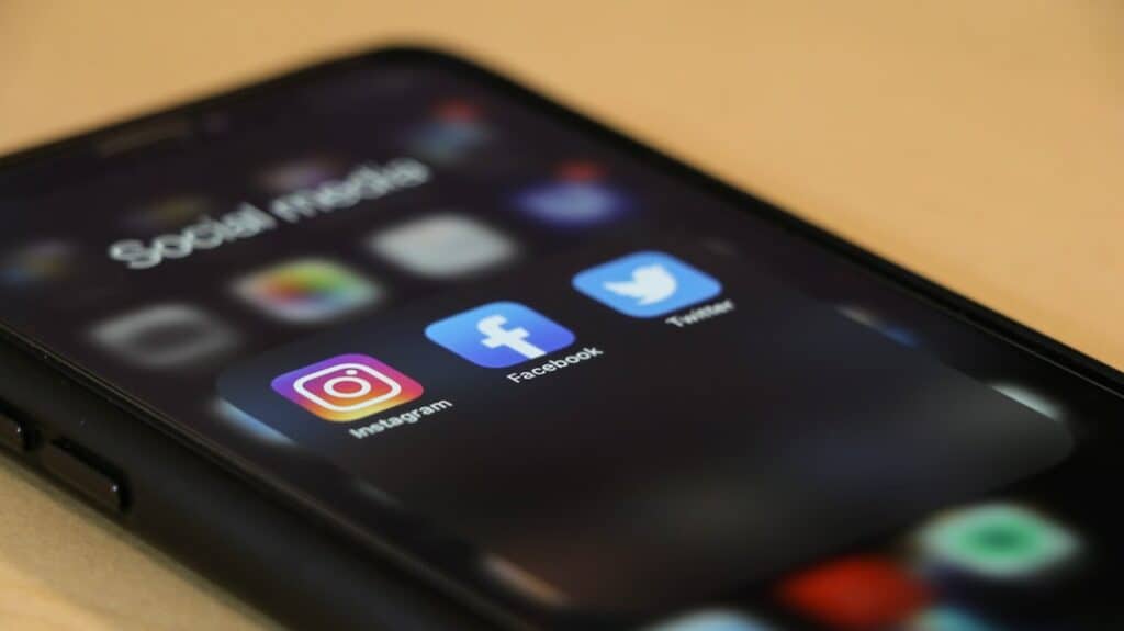 Smartphone showing social media apps representing Facebook ad cost