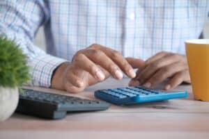 Calculator and financial charts representing Google Ads cost