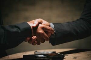 Business team shaking hands after choosing an agency