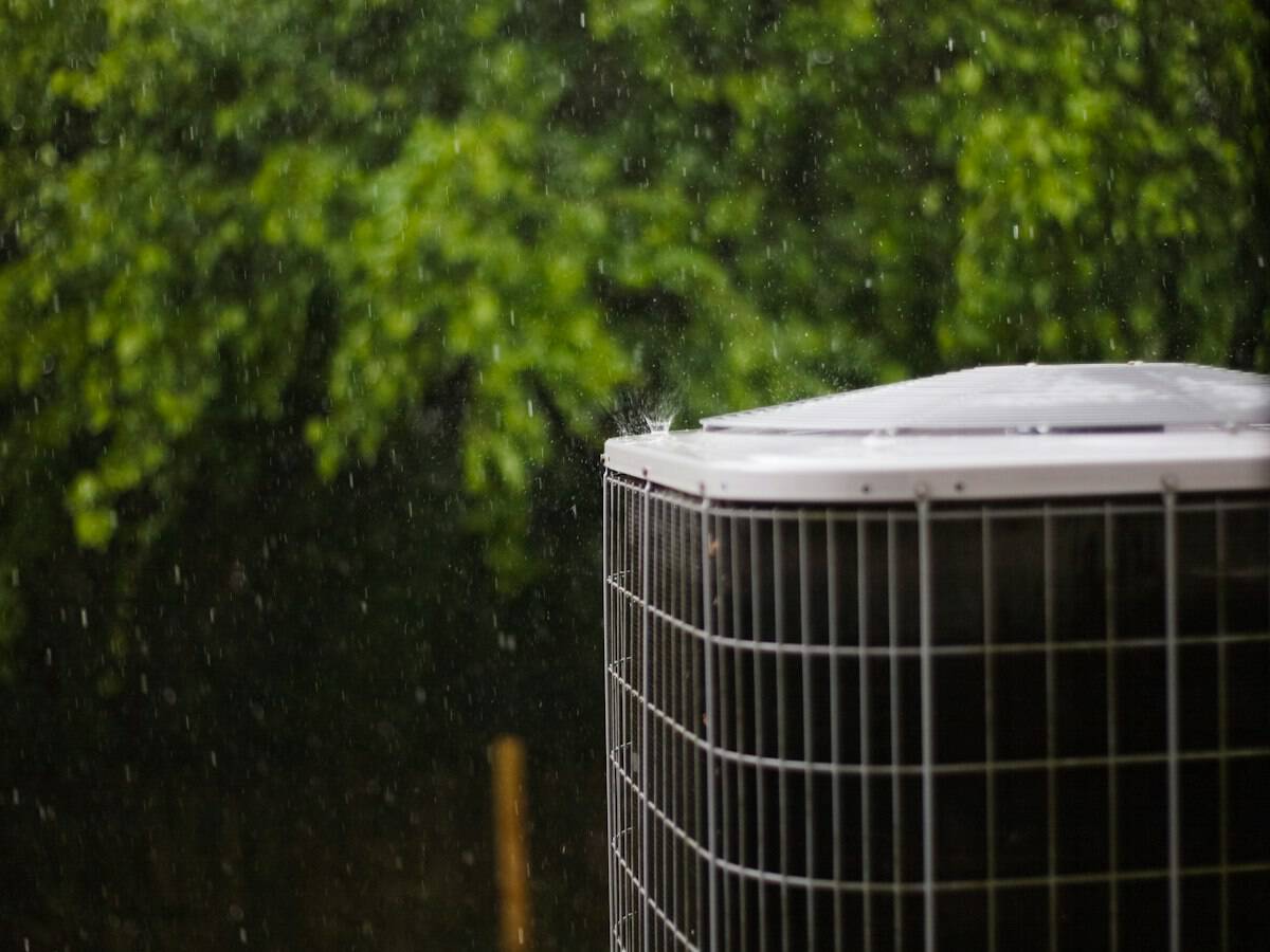 Air conditioner condenser unit in a backyard