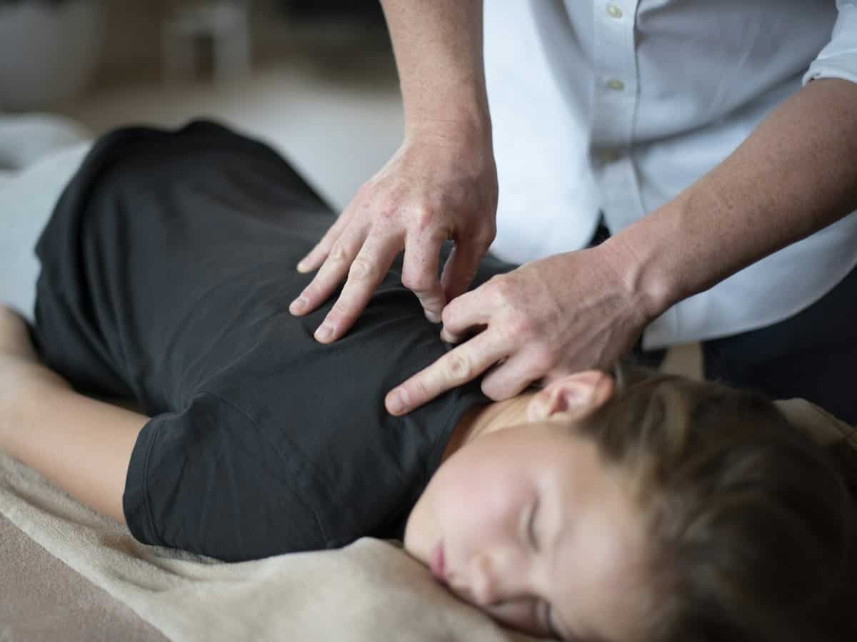 Chiropractor working on a patient neck and shoulders
