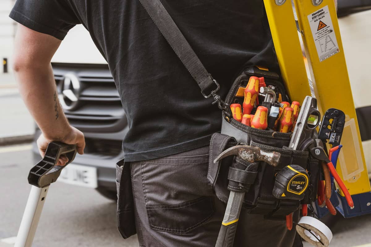HVAC technician carrying a tool bag to a service call