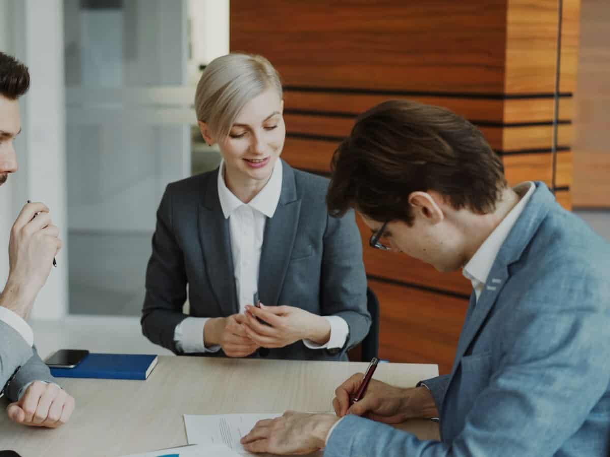 Attorney reviewing documents with two clients