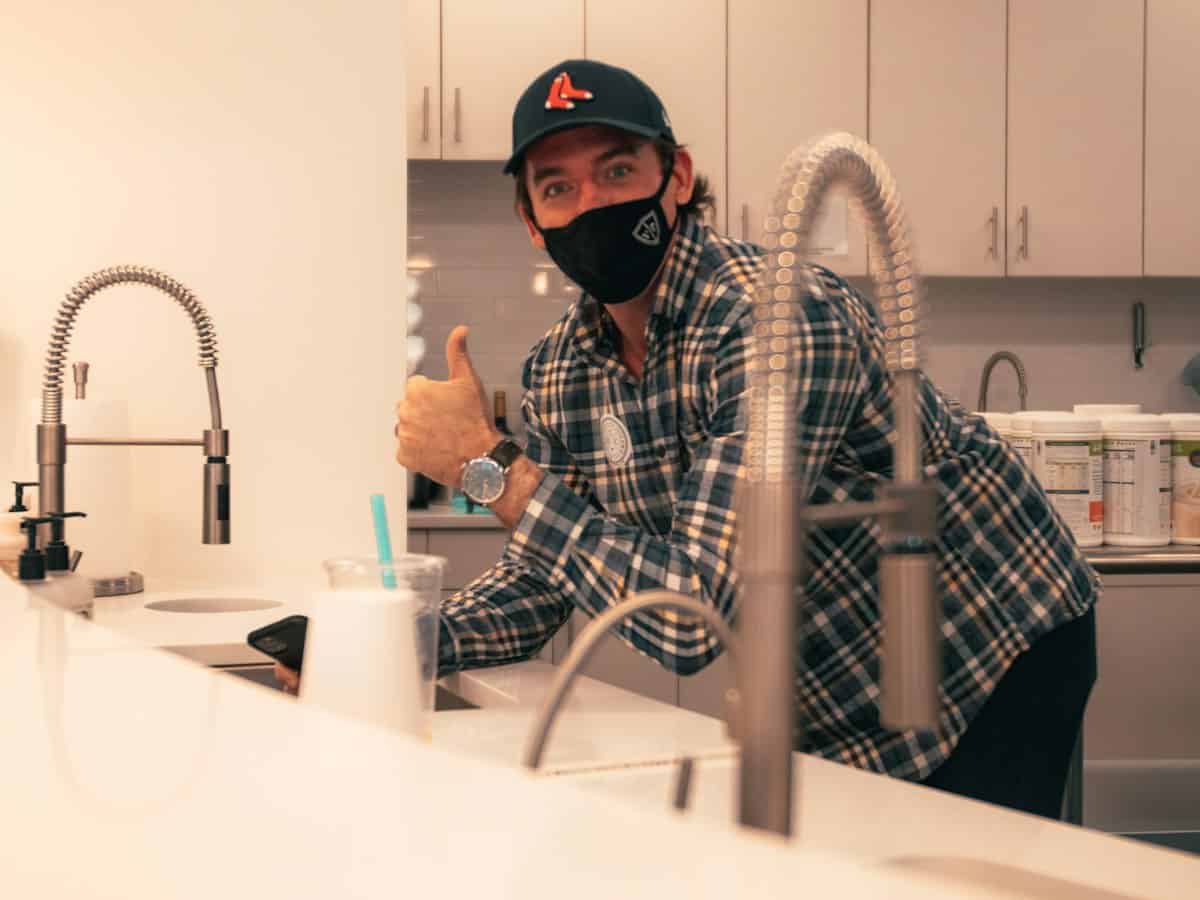 Plumber installing a kitchen faucet